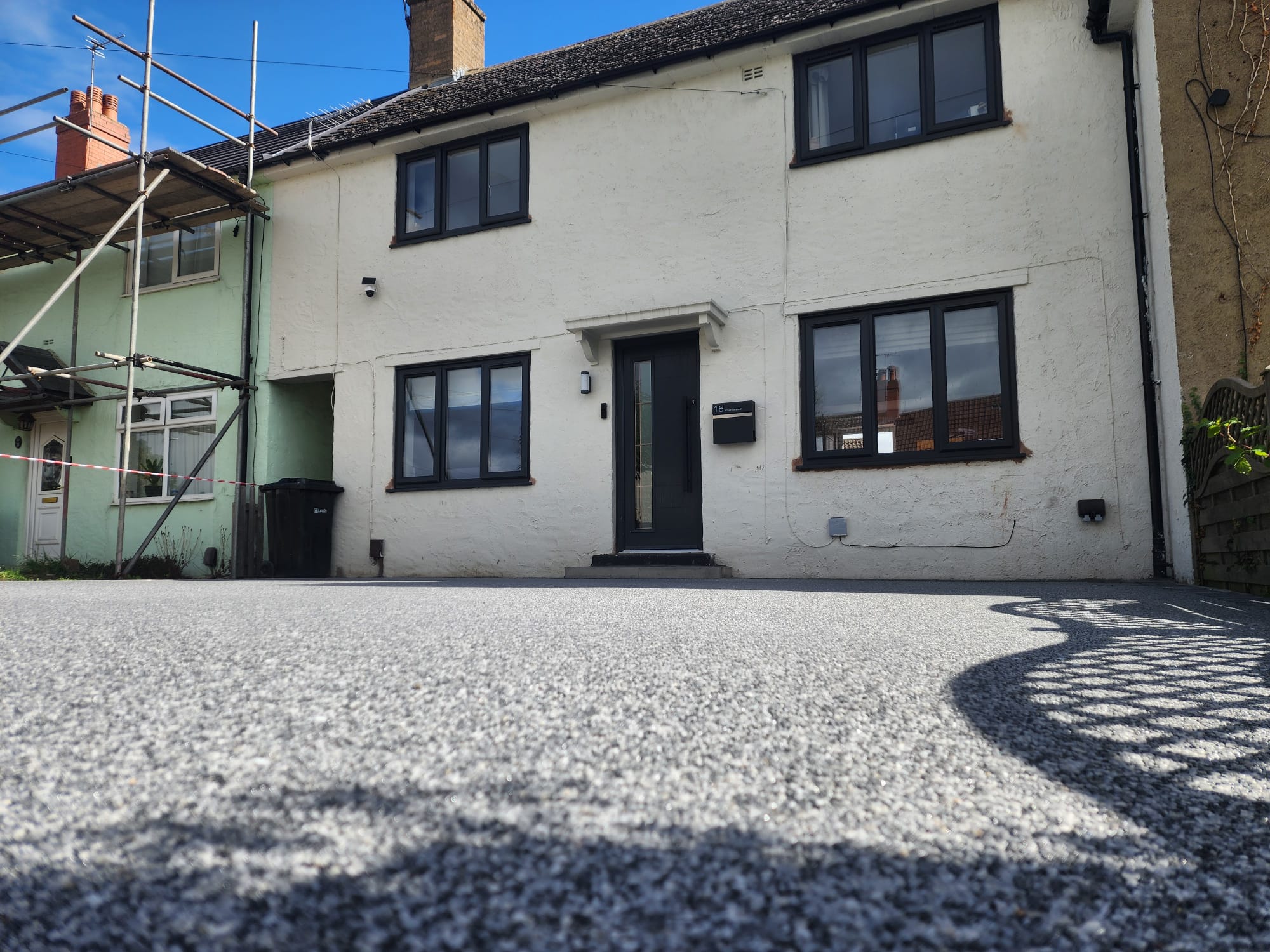 Completed grey resin-bound driveway at a white rendered house in Wetherby